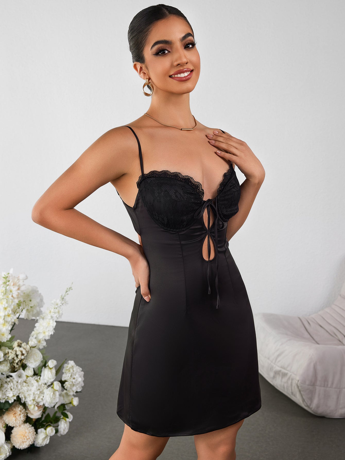 Back view of a sleeveless black satin dress