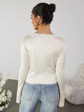 Back view of an ivory lace trim tie front top