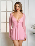Woman wearing a pink lace up mesh mini dress with long flounce sleeves