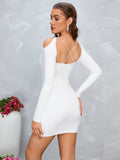 Back view of a white long sleeve mini dress with criss cross straps