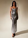Woman wearing a silver metallic maxi dress with a square neckline and sleeveless design.