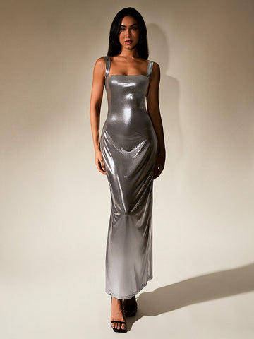 Woman wearing a silver metallic maxi dress with a square neckline and sleeveless design.