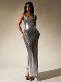 Full-length shot of a woman modeling a shimmering silver metallic maxi dress.
