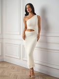 Woman wearing a beige one shoulder cutout lace maxi dress