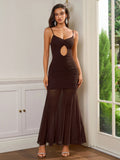 Woman wearing a brown maxi dress with a cut-out detail at the chest and ruched fabric on the torso.