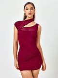 Woman wearing a red cut out twist front mini dress