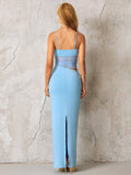 Back view of a blue fitted maxi dress with a split hem