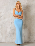 Full body shot of a woman showcasing a blue cut-out maxi dress