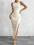 Full length shot of a beige fitted midi dress with a high split