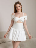 Woman wearing a white cut-out twist front mini dress with off-the-shoulder sleeves