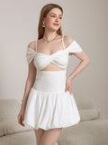 Full body shot of a woman in a white off-the-shoulder mini dress