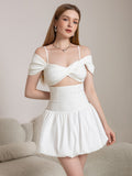Front view of a white mini dress with a sweetheart neckline and ruched skirt detail