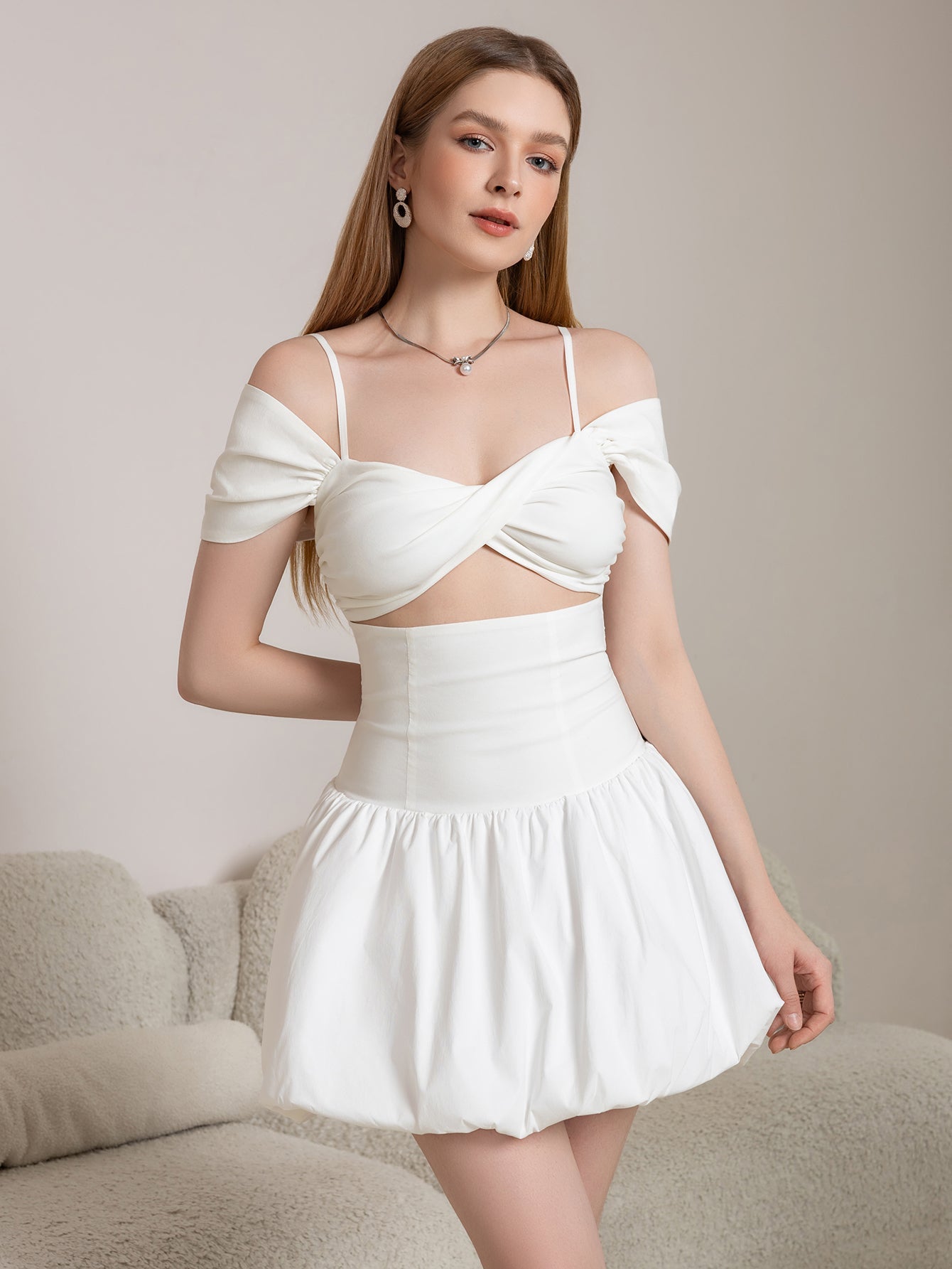 Front view of a white mini dress with a sweetheart neckline and ruched skirt detail