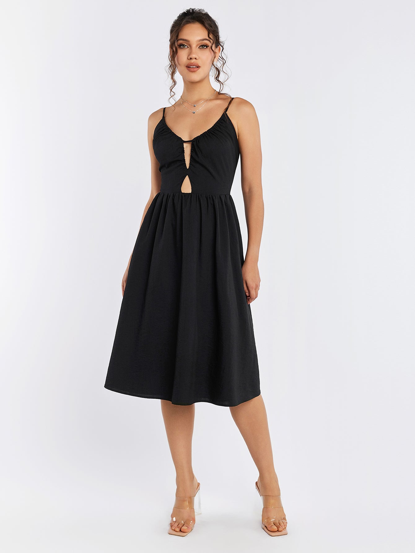 Woman wearing a black sleeveless cut out midi dress with a zipper back