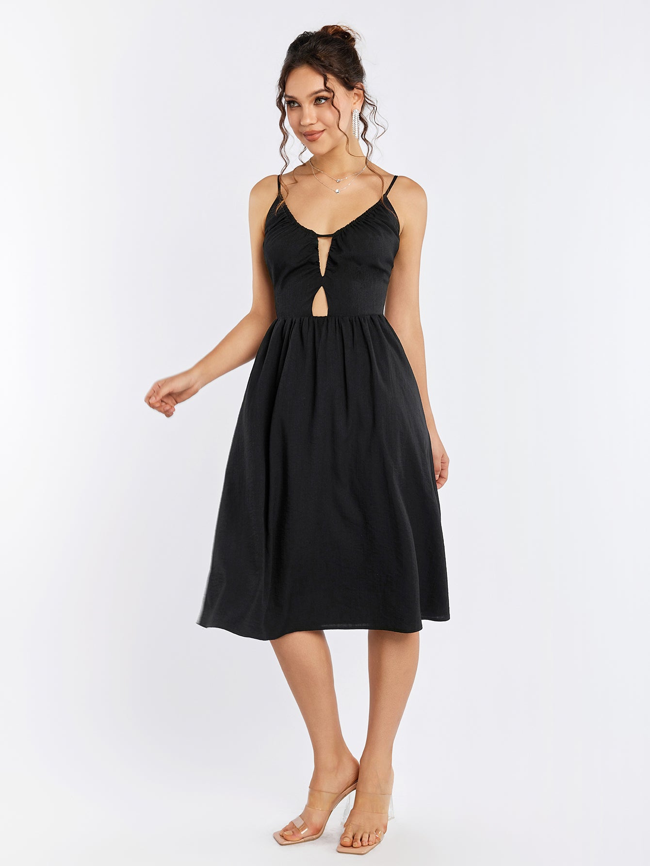 Full length shot of a woman in a black flared hem dress