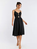 Front view of a black cami midi dress featuring a cut-out detail