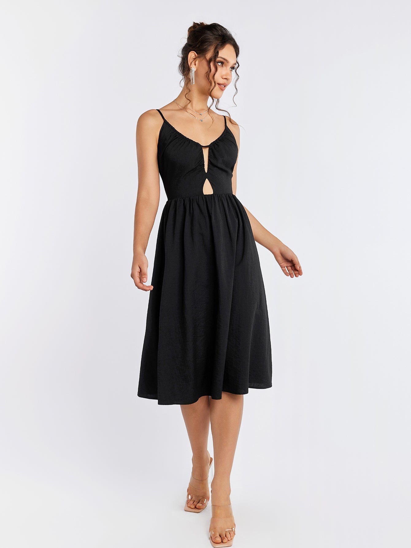 Front view of a black cami midi dress featuring a cut-out detail