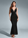 A model poses in a black V-neck sequin mermaid dress