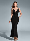 Woman wearing a black maxi mermaid sequin dress with a V-neckline and spaghetti straps