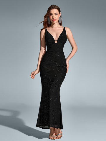 Woman wearing a black maxi mermaid sequin dress with a V-neckline and spaghetti straps