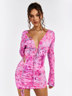 Close-up of the floral print and ruched detailing on a mini dress
