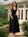 Full length shot of a woman in a black fitted midi dress with flared skirt.