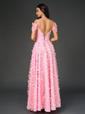 Back view of a pink floral applique prom dress with crisscross detailing