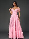 Woman wearing a pink floral applique V-neck maxi dress with off-the-shoulder sleeves