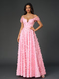 Close-up of the floral applique detail on a pink maxi dress
