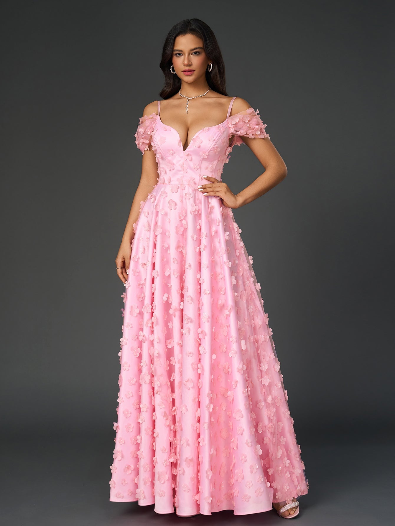 Close-up of the floral applique detail on a pink maxi dress