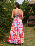 Back view of a woman in a floral print maxi dress showing the crisscross straps and smocked panel