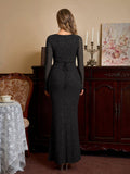 Back view of a black glitter maxi dress with a tie back detail