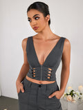 Model posing in a grey V-neck crop top and matching trousers