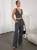 Full outfit shot of a woman in a grey crop top and cargo pants