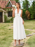 Close-up of the bow detail on a white halter neck maxi dress