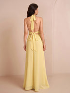 Back view of a yellow halter neck maxi dress showing the bow tie closure