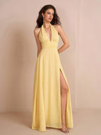 Woman wearing a yellow halter neck maxi dress with a deep V-neck and split thigh