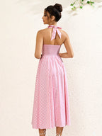 Back view of a pink plaid halter neck midi dress