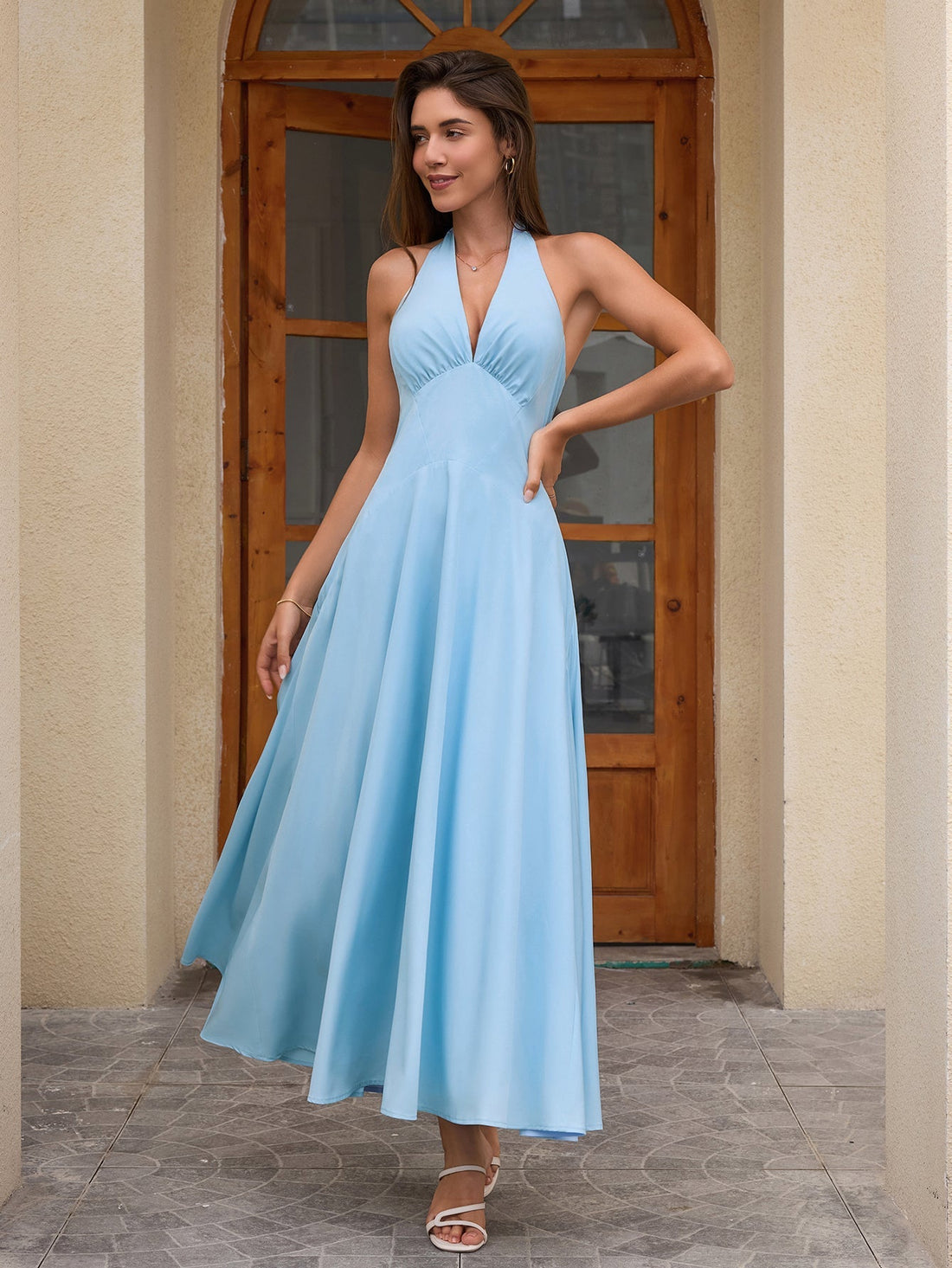 Woman wearing a light blue maxi halter neck dress