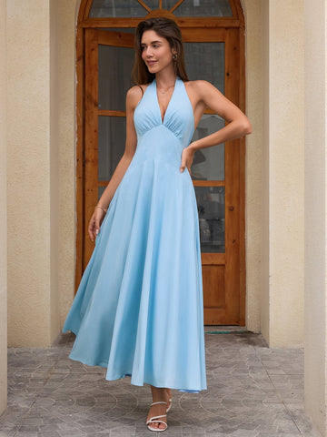 Woman wearing a light blue maxi halter neck dress