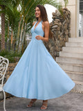 Woman twirling in a blue halter neck A-line maxi dress
