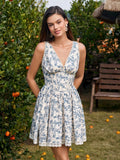 Woman wearing a blue and white floral print mini dress with lace trim and a V-neckline