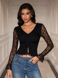 Fashionable black crop top with intricate lace sleeves