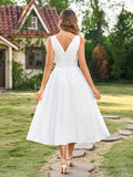 Back view of a white V-neck maxi dress with flared skirt
