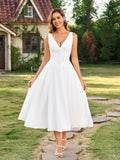 Woman wearing a white sleeveless maxi dress with V-neck and button front