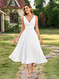 Model posing in a white button-front maxi dress outdoors