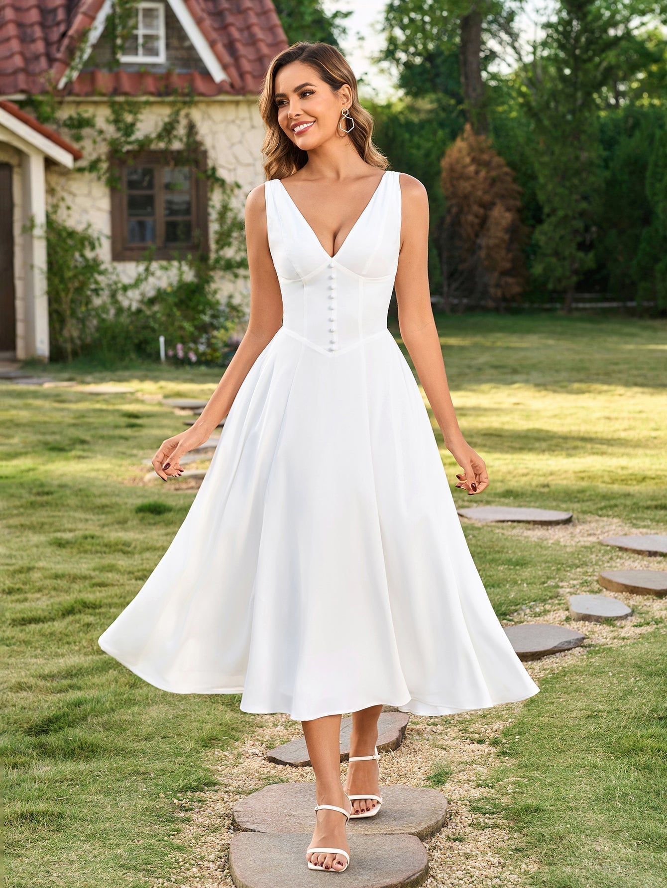 Model posing in a white button-front maxi dress outdoors