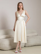 Full length of a beige satin A-line midi dress