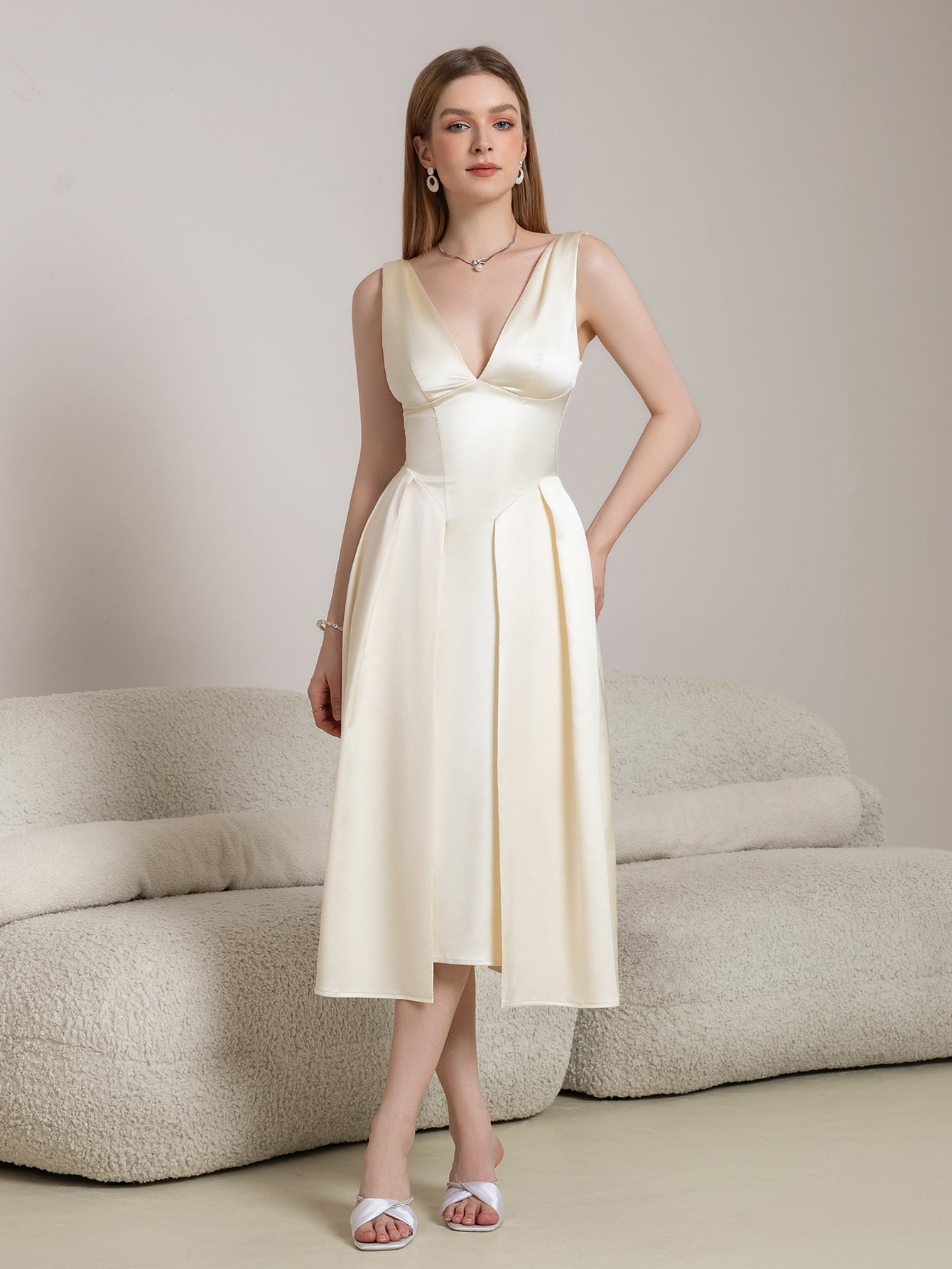 Full length of a beige satin A-line midi dress