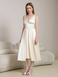 Detail of the V-neckline on a beige satin midi dress